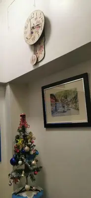 a christmas tree in a room with a clock at Victory Room in Bangkok