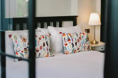 a bedroom with a bed with pillows on it at The Residences at C&C in Bangkok