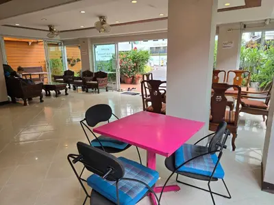 a pink table and chairs in a room at Bella Bella Riverview in Bangkok