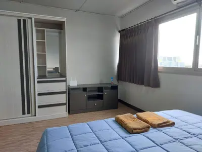a bedroom with a bed with two towels on it at Solitude Skies14th Floor Studio in Nonthaburi