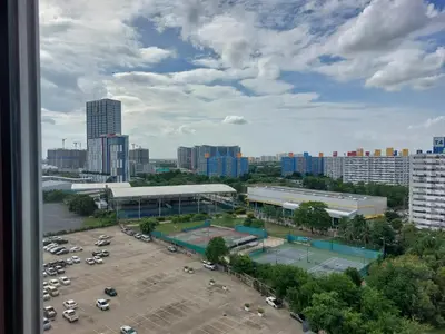 a view of a parking lot with a tennis court at Solitude Skies14th Floor Studio in Nonthaburi