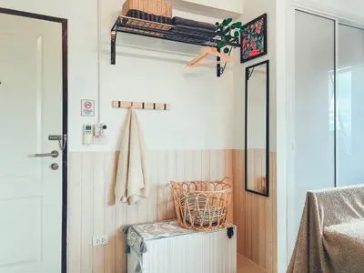 a room with a closet with a bed and a mirror at The Giftown Bangkok, Talat Phlu in Thonhuri