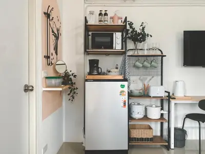 a kitchen with a refrigerator and a microwave at The Giftown Bangkok, Talat Phlu in Thonhuri