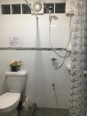 a bathroom with a toilet and a shower at Silver Room Guest House Very Close Bangkok Hospital in Bangkok