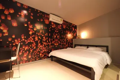 a bedroom with a bed and a wall with red lights at Everyday Bangkok Hostel in Bangkok