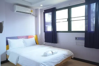 a bedroom with a white bed and a window at Room@Vipa in Bangkok