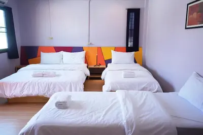 a room with three beds with white sheets at Room@Vipa in Bangkok