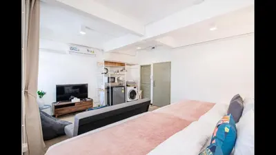 a bedroom with a large bed and a television at 3A-168 House Near BTS-icon siam in Godown