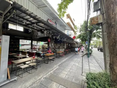 a restaurant with tables and chairs on a city street at 3A-168 House Near BTS-icon siam in Godown