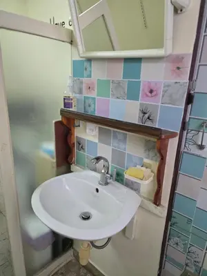 a bathroom with a sink and a mirror at J Place Studio 204 with nice fan free Wifi, near Skytrain in Bangkok