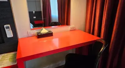 a red desk in a room with a mirror at The Park Residence in Bangkok