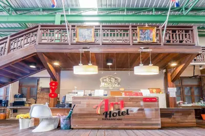 a hotel with a table and a chair in a room at Art Hotel Sanamchai in Bangkok