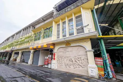 a yellow building on the side of a street at Art Hotel Sanamchai in Bangkok