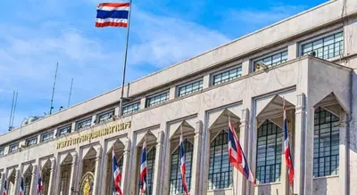 a building with three flags on top of it at Art Hotel Sanamchai in Bangkok