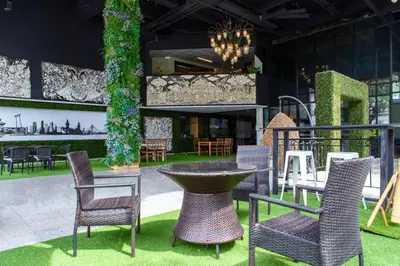 a group of chairs and a table in a building at Town In Town Gardent Resort in Sathani Khlong Tan