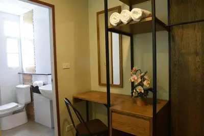 a bathroom with a sink and a toilet and a mirror at Home Inn Hotel in Bangkok