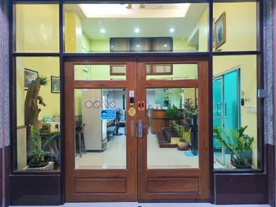 a door to a building with potted plants at Sunflower Place in Bangkok