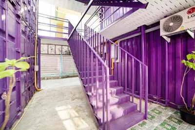 a purple staircase in a building with a purple wall at 5 Diamond in Bangkok