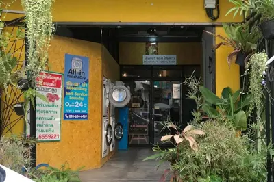 an entrance to a store with a motorcycle parked outside at OYO 505 Ente Space Hostel in Bangkok