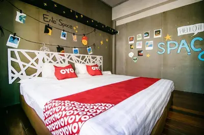 a bedroom with a white bed with red pillows at OYO 505 Ente Space Hostel in Bangkok