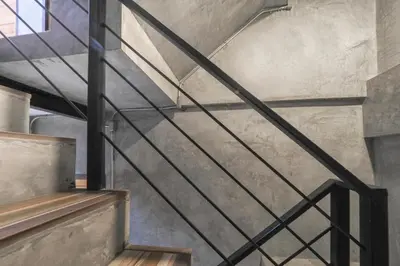 a staircase in a building with a metal railing at OYO 935 The Palm Apartment in Bangkok