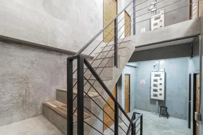 a spiral staircase in a building with a stair case at OYO 935 The Palm Apartment in Bangkok