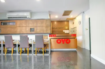 a kitchen with a table and chairs in a room at OYO 1002 Pinklao Resort in Bangkok