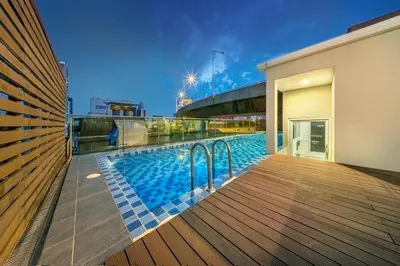 a swimming pool on the roof of a building at Ralph Poshtel Pratunam in Bangkok