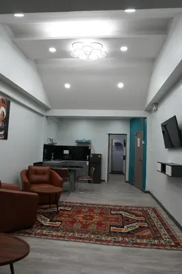 a living room with a couch and a piano at SkyLink Homes - Pattunaam - Airport Link & BTS Chidlom in Bangkok
