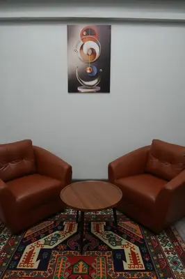 a living room with two chairs and a table at SkyLink Homes - Pattunaam - Airport Link & BTS Chidlom in Bangkok