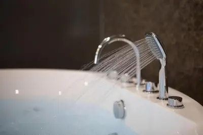 a sink with a faucet with water coming out of it at The Valen Resort in Bangkok