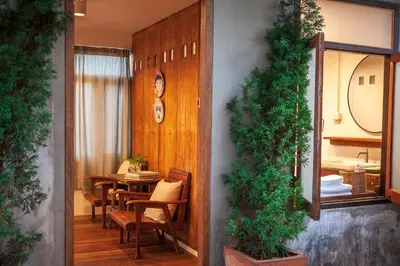 a dining room with a table and chairs and a tableablish at Mana Craft Stay in Bangkok