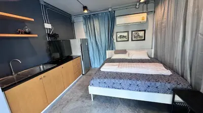 a small bedroom with a bed and a sink at Bangkok Silom chat box hostel in Bangkok