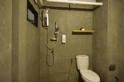 a bathroom with a shower and a toilet in it at Bangkok Silom chat box hostel in Bangkok