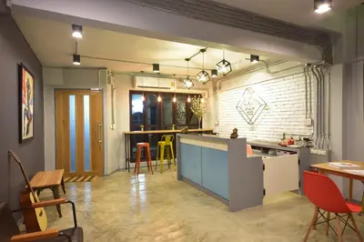 a large kitchen with a counter and a dining room at Bangkok Silom chat box hostel in Bangkok