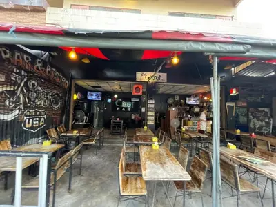 an empty restaurant with wooden tables and chairs at 168 House 3B Near BTS iconsiam in Godown