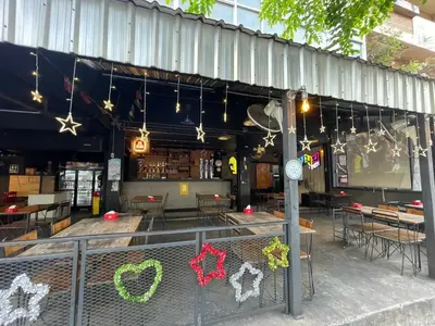a store front with tables and chairs and lights at 168 House 3B Near BTS iconsiam in Godown