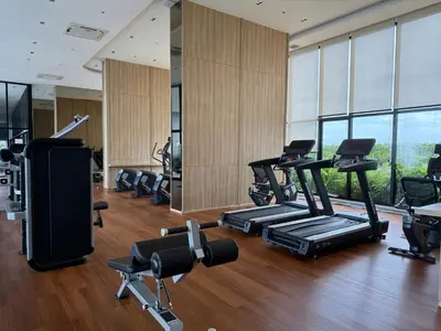 a gym with treadmills and ellipticals in a building at Cozy Downtown Apartment - long stay in Bangkok- MRT Phasi charoen in Bangkok