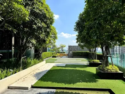 a garden with grass and trees in a building at Luxury Art apt Downtown Metro Bangkok-Kitchen-living room in Bangkok