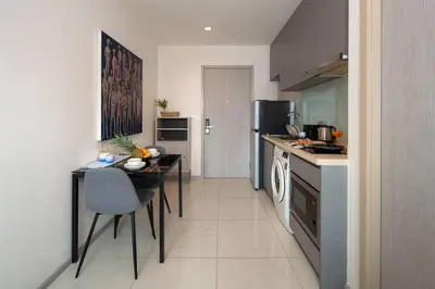 a kitchen with a table and a dining room at Luxury Art apt Downtown Metro Bangkok-Kitchen-living room in Bangkok