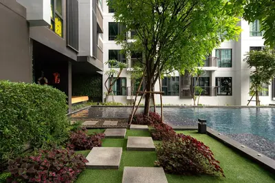 a swimming pool with a tree in the middle of a building at Luxury Art apt Downtown Metro Bangkok-Kitchen-living room in Bangkok
