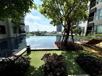 a swimming pool with a tree in the middle of a building at Luxury Art apt Downtown Metro Bangkok-Kitchen-living room in Bangkok