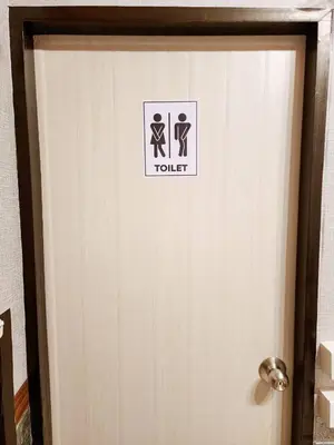 a bathroom door with a toilet sign on it at 109 Homely Apartment Free Wi-Fi Near BTS in Bangkok
