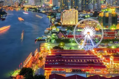 a city skyline with a ferris wheel and a river at XX GO INN Asiatique Charoen krung V โกอินน์ เอเซียทีค เจริญกรุง in Bangkok