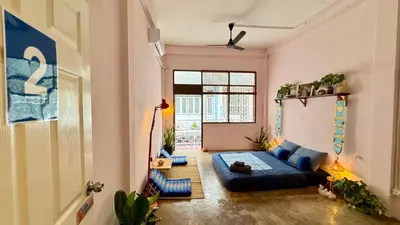 a living room with a blue couch in a room at Baan YentaFo - Pink House 2nd floor in Chinatown