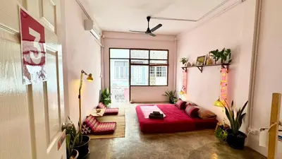 a living room with a red couch in a room at Baan YentaFo - Pink House 3rd floor in Chinatown