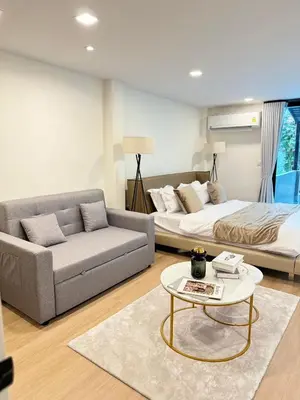 a living room with a couch and a bed and a table at 4Beds 4Baths New Renovated Entire House BTS Ekkamai in Bangkok