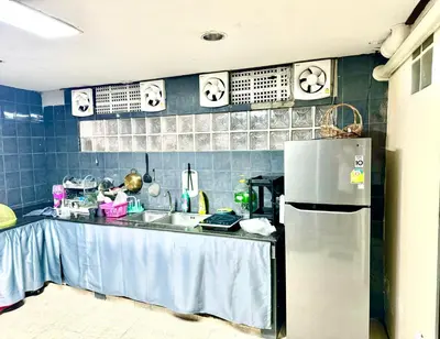 a kitchen with a sink and a refrigerator at Twenty One Place in Bangkok