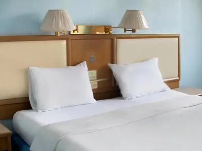 a bed with two white pillows in a room at XX Wish Inn Chidlom V วิช อินน์ ชิดลม 2 in Bangkok