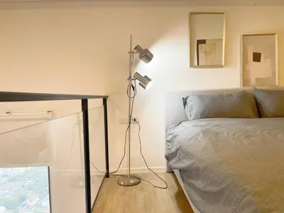 a bedroom with a bed and a desk with a lamp at 2BR BTS On Nut Siamese87 Two Bedroom LOFT hight floor 24 in Bangkok
